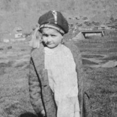 Ruby E. Taylor - 5 years old standing in the yard at home in Buskirk, KY - that is Matewan, WV behind her.