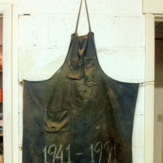 Rudy's first shop apron, memorialized on the shop wall