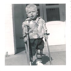 Russell with his crutches after being in Gonzales for his Polio