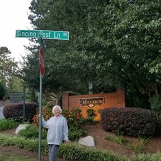 Ruth is posing with the street sign for Grace's house in Georgia