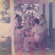 (Foreground) Ruth's Mom Bessie and sister Eileen Lovell shelling beans. (Background) L. to. R. Ruth, Sally, Pud Lovell, sister Ann Amundsen.playing cards.
