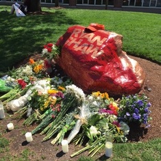 The students of Northeastern have left flowers and candles at the rock painted in honor of Ryan by his Pike brothers.
