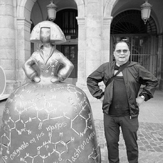 Tito Ramon posing his goofy pose beside a statue in Spain