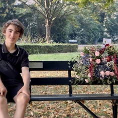 Jarin on Sabine's bench with the flower arrangement we both had ordered