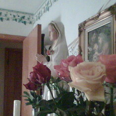 MOM'S  CATHOLIC FAITH AND FAMILY WERE ALL THAT MATTERED...The Rosa Mystica Pilgrim Virgin Statue given to Mom from daughter Lynette and Roses the last ones given to Mom while she was here the last of many arrangements given to her by son Bruce.