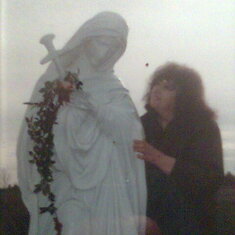 MOM BY A STATUE OF OUR LADY OF SORROWS IN KENTUCKY AT THE SHRINE