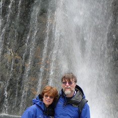 Ken and Sandee at a waterfall at Franz Josef glacier in New 
Zealand