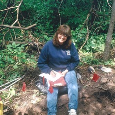 Sandy doing Archaeology with her mom and dad.