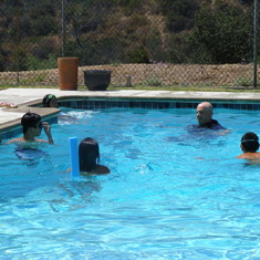 Micielli, Andrew, Ally, and Chris in the pool with Uncle Scott