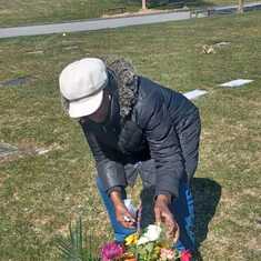 Aunty Blossom Williams laying flowers at Uncle Scotty grave today, remembering him on his birthday.