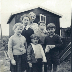 Charles's five children standing in front of Charles's garden studio ('The Shed') where he used to paint signs, portraits and landscapes.