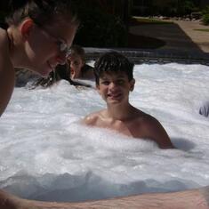 Shai getting in the hot tub at the paragon with austin