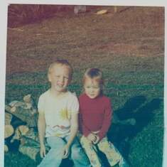 Billy and Shannie sitting on a log pile