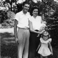 Sharon with mother Audrey (holding brother Douglas) and father Donald as a little girl circa 1953