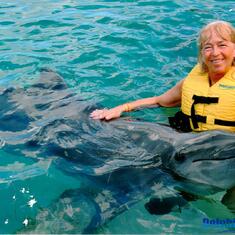 Sharon swimming with a dolphin