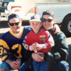 Shawn at his first tailgate party and Rams game with Uncle Steve and Uncle Kevin