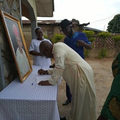 Bishop Francis Adesina signing condolence register at Villa Ayoka