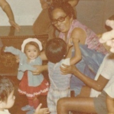 Guadalupe Zurbito Reyes ("Mommyba") holding Joanna. The antique chest in the background is still with the family.