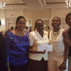 International Chapter executive  presenting a book scholarship to Sister Angella