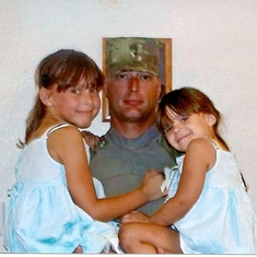 Travis before deploying in 2010 holding his two beautiful daughters , Madison & Gianna , that he wanted to witness grow into women .