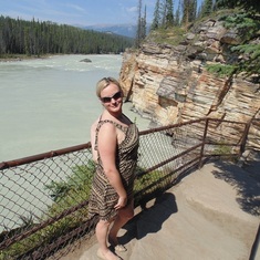 Posing for a picture and Athabasca River valley in the background, always smiling, sweet heart