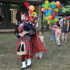 Parade of Stan's grandchildren with 90 balloons led by friend and bagpiper Chris Anderson at the birthday celebration in September.