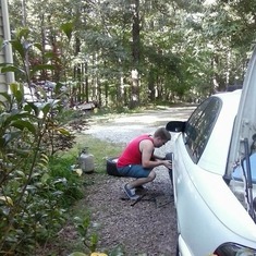 Josh changing a tire for Steph