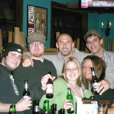 steph and john with friends  at a bar