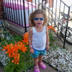 Abrianna standing in front of Daddy's lillies. 6-15-10