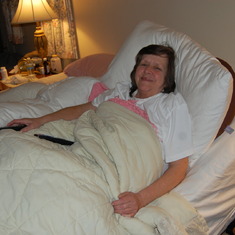 Mom resting in her "million dollar" bed