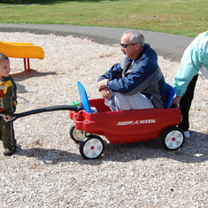 Mom and Jordan trying to pull Ron in the wagon