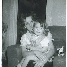 My mom holding me as a little girl