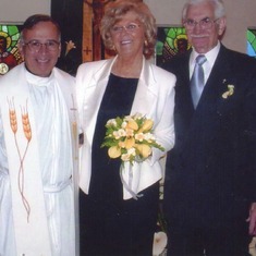Renewing their vows in 2005 in the Catholic Church (pictured with Father Arnold Ortiz OSG)