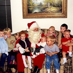 Terre, Ruby, a bunch of 2nd cousins with Santa (Uncle Will) in the middle and cousin Sandi onthe right.