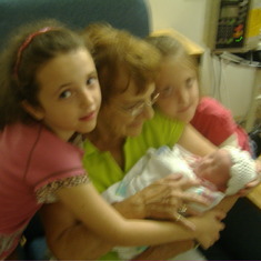 Mom, Katie and Emmie holding newborn Maddie