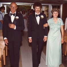 Mom and Dad walking Jeff down the aisle in 1980. Mom is the one on the right.