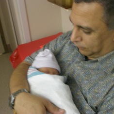 Tom holding his granddaughter, Nai'a, only 4 days old.