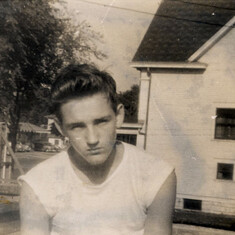 Tom next to home at 738 University Ave., 1946 (age 15)