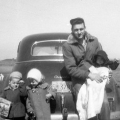 Tom with Mark, Peggy and Colleen, on road in front of Mendota home, 1956