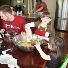 Cookie making for Christmas . . . everyone on deck . . . Papa in the background wearing Momma's apron.
