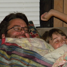 Matthew's favorite place to be is snuggled up with dad in the "snuggler" watching TV.