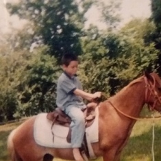 Aaron on one of your daddy's horses