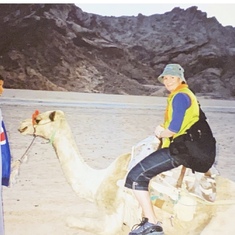 Tracy riding a camel in the desert, just outside of Cairo