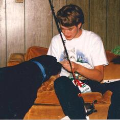 He got  a new rod and reel Christmas 1996, his dog checking it out.