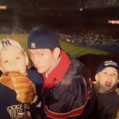 Trevor age 5, with Daddy,Mommy, and John enjoying the Yankee Game.