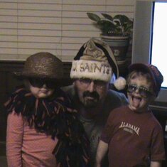 Dressing up: Elizabeth in a hat and boa, Shane Hays in his sunglasses and Uncle Trey in the Saints hat.