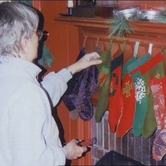 Tuck at Christmas hanging stockings. She sewed stockings for all eighteen of the Loui clan. 