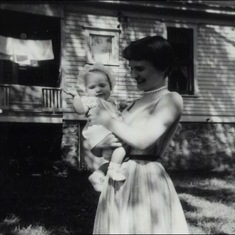 Tuck looking incredibly stylish with baby Anne, 1957.