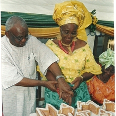 Chief Obasi assiting Mama to cut her Uche cake