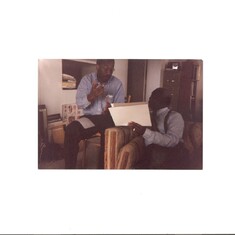 Chief Obasi discussing his medical records with nephew Dr. Joe Odim in Boston